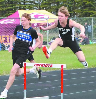 Clearing the hurdles, Shawn Patterson pulls ahead of the competition in the JH Boys 200m Hurdles. Patterson won the event with a personal best of 27.69. Photo by Jamie Rarick