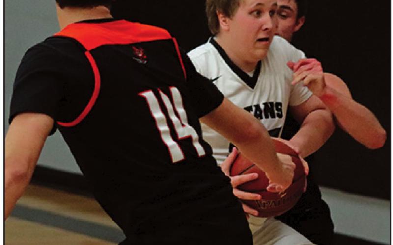 Lukas Pastorek tries to maintain possesion of the ball against Adre Carrier and another Tornado. VNV Photo by Lesa Van Camp