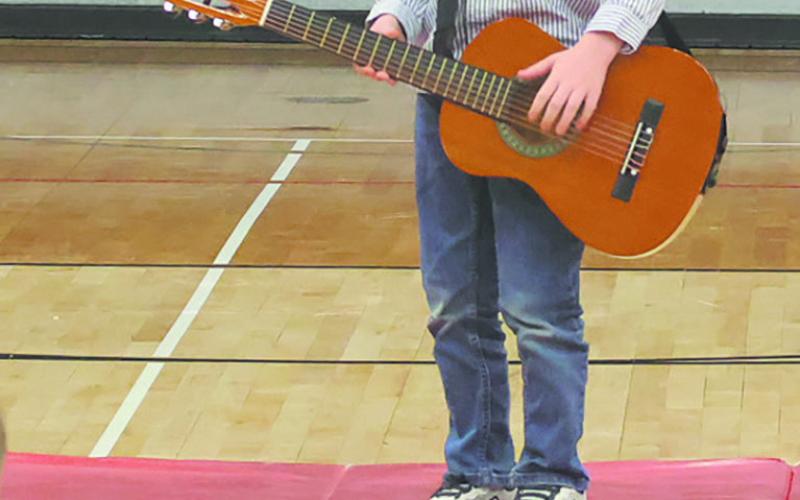 Mac entertains the crowd with his guitar. Photo by Jamie Rarick