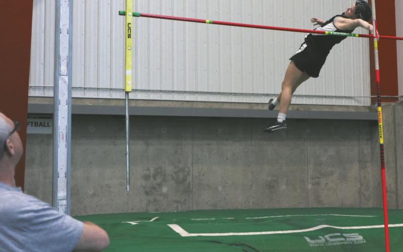 Alyssa Hoyles clears the bar on her way to tying the Titans indoor record.