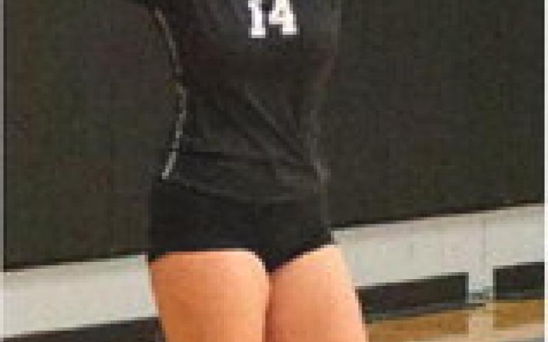 Aleah Pokrzywinski concentrates on her serve against HVC. Photo by Lyle Van Camp.