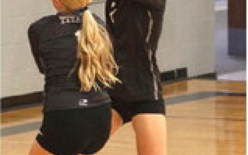 Reese Ferring and Alyssa Hoyles try to save a volley in the Drayton Gym last Thursday. Photo by Lyle Van Camp.