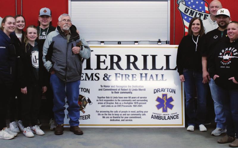 Members of the Merrill family and the new sign which will soon grace the fire and ambulance Hall. VNV photo by Lyle Van Camp