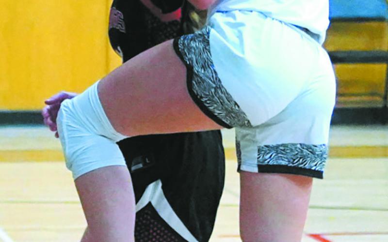 Jaelyn Johnson prepares for a lay up while Midway-Minto attempts to block the shot. Photo by Larry Stokke