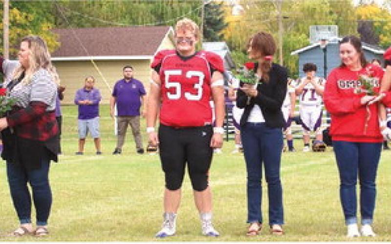 The Bombers Seniors and their parents were introduced at the start of the New Town game. From the left; Juan and Jessie Navarro and Gavin Ryan; Bryce Wimpfheimer and his mother Kristi Wimpfheimer; Maggie Vold, Grant Vold, and Matt Vold.