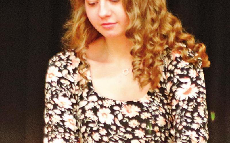 Kayli Staskivige lights a candle during the NHS Induction Ceremony Monday night. VNV Photo by Lesa Van Camp