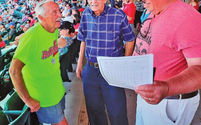 Pictured left to right are: Ray Long, Bill Long, and Mark Tungseth visit at a Red Hawks game last week. Photo submitted by Clint Van Camp