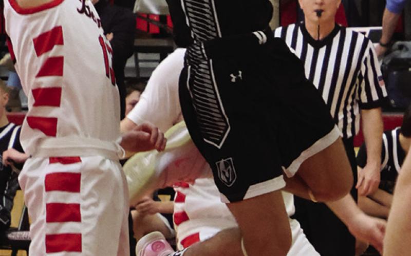 Trenten Keena tries to shoot through two North Star defenders.