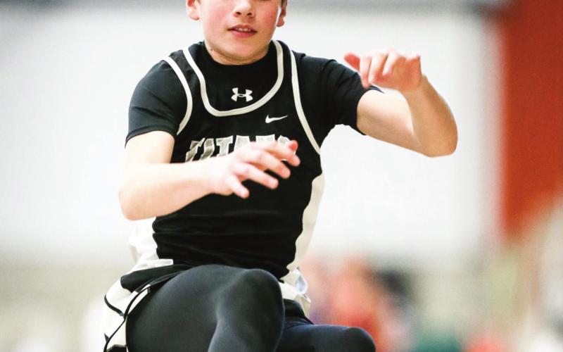 Sam Kittelson makes an effort during the long jump last Friday Night at UND. Photo by Cole Short courtesy of Hillsboro Banner