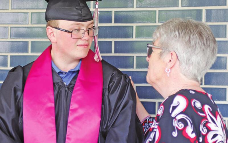 Cole Wilson and Mary Lou Feilen exchange greetings during the reception line following the graduation ceremony on Sunday afternoon. VNV Photo by Lesa Van Camp