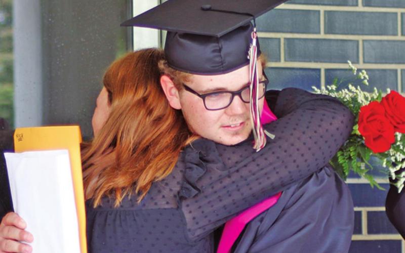 Siblings Ali and Nick VanCamp share a hug following the DHS graduation. VNV Photo by Lesa Van Camp