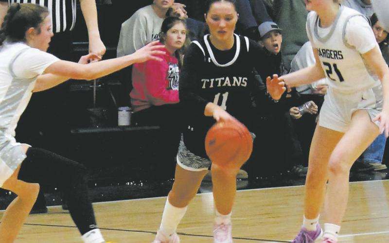 MORE SPORTS PAGE 2 Jacey Nelson splits through the Nelson County defenders on her way towards the basket. Photo by Jamie Rarick
