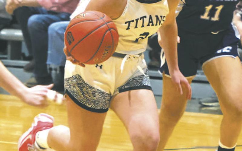 Trying to break loose from the Defenders with the ball, DVE senior Brooke Gullickson races down the court. Photo by Jamie Rarick