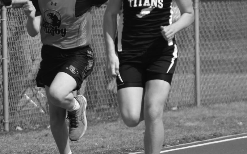Samuel Kittleson, right, stays a step ahead of a runner from Rugby in the 100 meter dash.