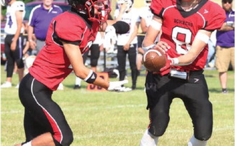 Trenton Keena receives a handoff from Gavin Ryan. Photo by Lyle Van Camp.