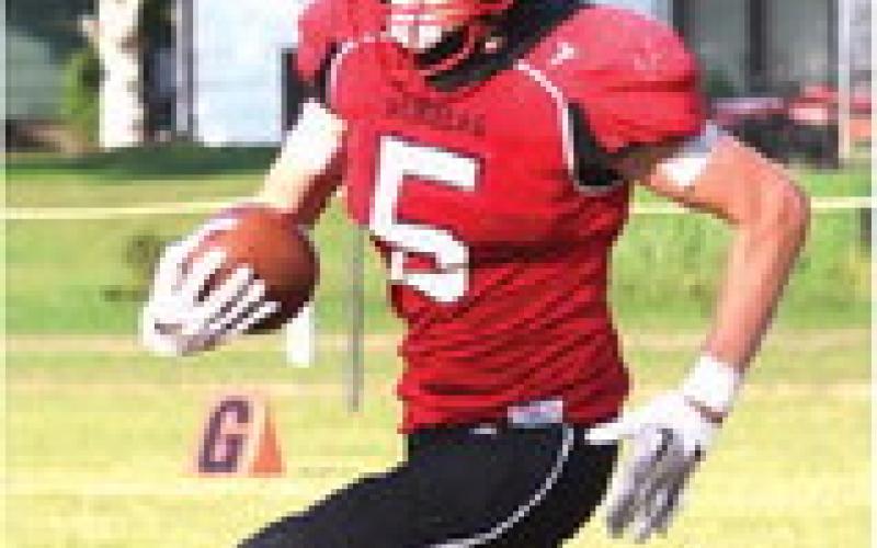 Grant Vold carries the ball in action against P-NSP last Saturday. Photo by Lyle Van Camp.