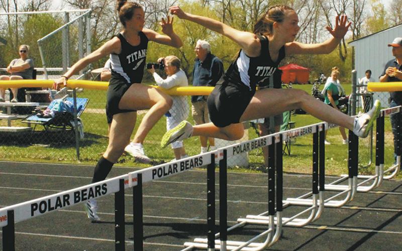 DVE teammates Jocelyn Vold and Elizabeth Fedje leap over the hurdles to a 2nd and 3rd place finish respectively, both moving on to the state competition in the womens 100m hurdles. Photo by Jamie Rarick