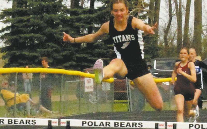 DVE teammates Jocelyn Vold and Elizabeth Fedje leap over the hurdles to a 2nd and 3rd place fi nish respectively, both moving on to the state competition in the womens 100m hurdles. Photo by Jamie Rarick