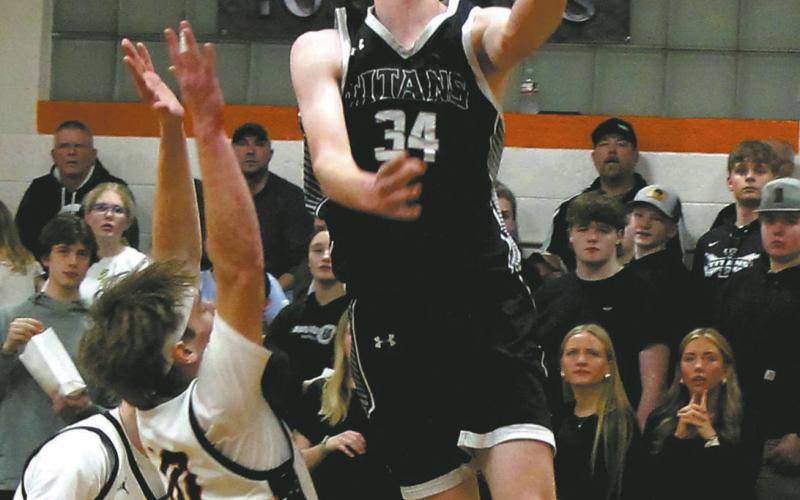 Jack Langerud takes to the air past defenders for the layup. Photo by Jamie Rarick