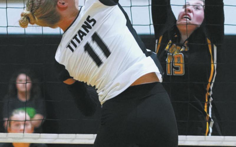 DPS senior, Alyssa Hoyles slams the ball over the net in the match against Park River. Photo by Larry Stokke.