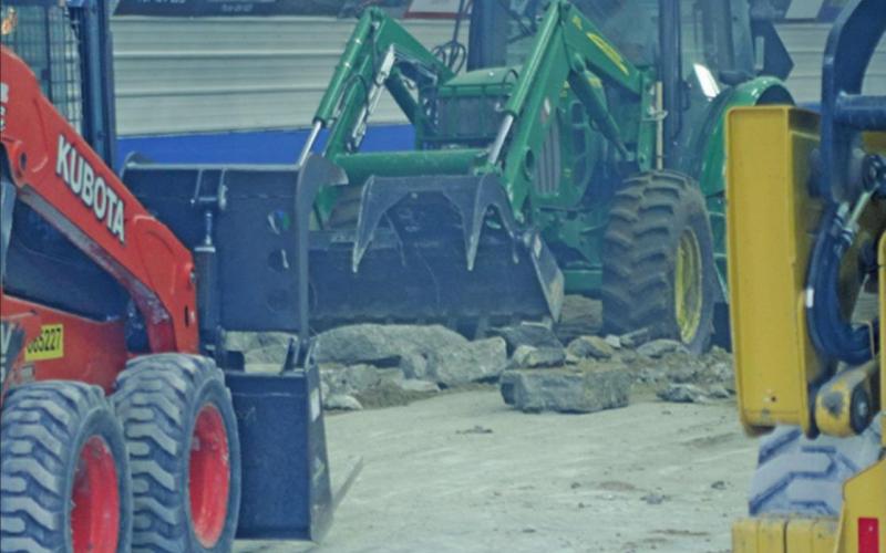 Boys just playing in their toys. Removing the old concrete floor from the Drayton Curling Club kicked up the dust and made quite a haze on a hot summer evening last week. VNV Photo by Lesa Van Camp