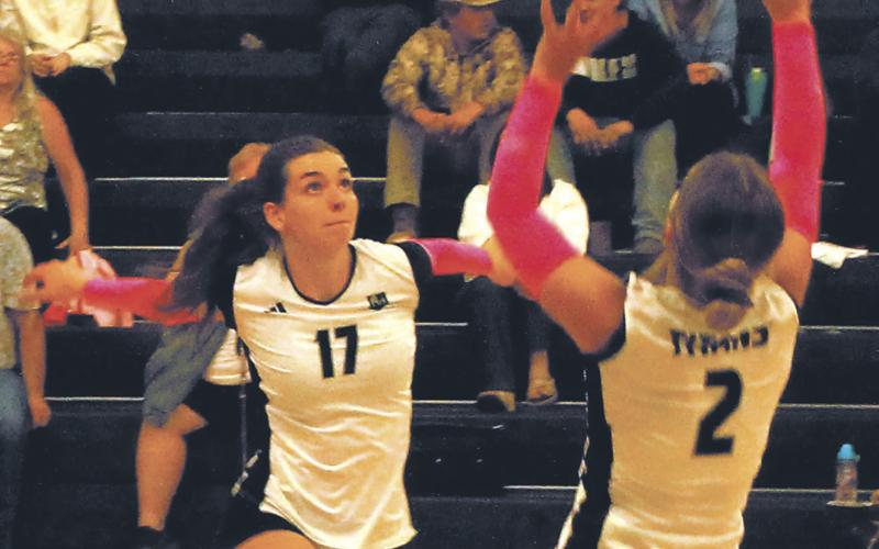 Brooke Gullickson sets the ball as Elizabeth Fedje moves in for the spike. Photo by Jamie Rarick