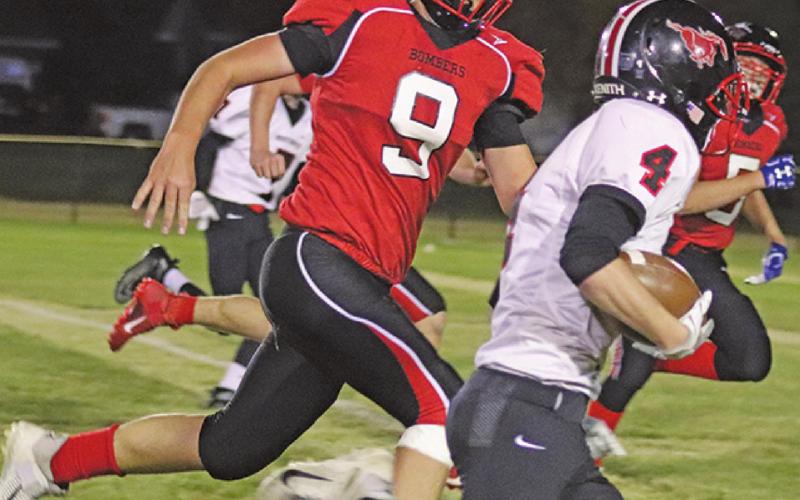 Damian Pokrzywinski tries to catch and stop Mustang Austing Almen from scoring last Friday night on the Drayton field. VNV Photo by Lesa Van Camp