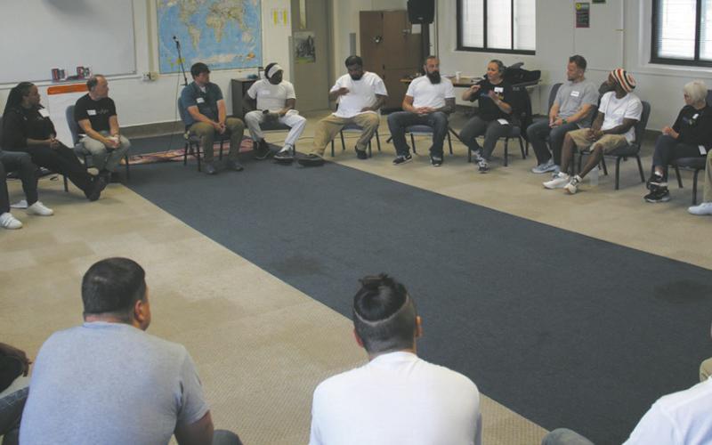 North Dakota DOCR Director Colby Braun joins Shining Light staff and the first Academy cohort at Missouri River Correctional Center — to reflect on the journey and the impact the program has in their lives. Photo provided by Shining Light.