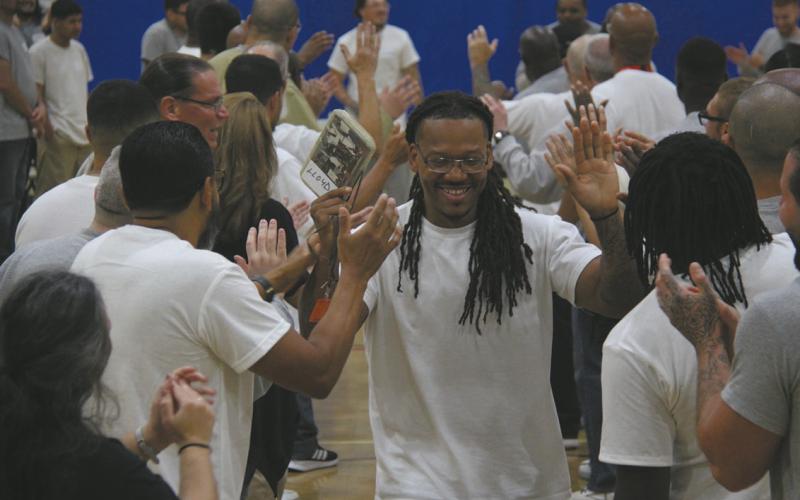At North Dakota State Penitentiary, Shining Light Academy graduates run the 'gauntlet' — a tunnel of high-fives from fellow residents honoring the courage, growth, and commitment it takes to complete a program designed to help them thrive inside and succeed beyond these walls. Photo provided by Shining Light.