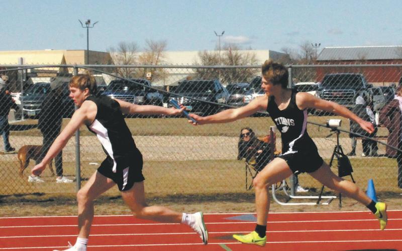 With a flawless handoff, Carter Oberg receives the baton from Sam Kittelson in the men’s 4 x 200 relay. The team placed 3rd, setting a new personal record for the event. Photo by Jamie Rarick