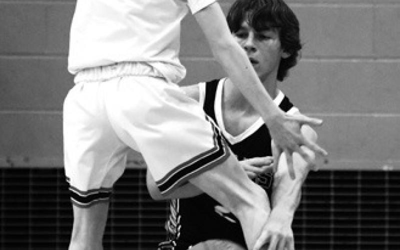 Logan Wieler makes a pass between the legs of Elijah Robinson. Photo by Lyle Van Camp.