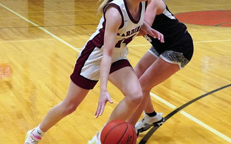 Editor’s note: This is the final year of educational instruction for Edmore Public School. Tip off for the very last game on Edmore’s home court was at 7 p.m. on Thursday, Jan. 25 when the Langdon-Edmore-Munich girls basketball team played one last game at the school against Drayton-Valley-Edinburg. Hilary Haaven drives around D-VE’s Greta Burrell at Edmore gym’s final game. Photo by Larry Stokke.