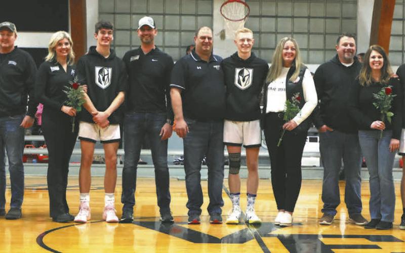 The Titans seniors stand with their parents on Senior Night, which was celebrated Feb. 13 at the game against Park River. Photo by Lyle Van Camp.