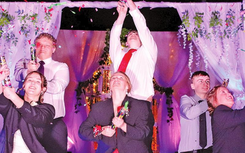 Time was taken out by these couples to set off confetti during the Prom Grand March on Saturday Night. Pictured left to right are: Hailey Berg and Bryce Wimpfheimer, Aleah Pokrzywinski and Ian Peterson, and Grant Vold and Claire Thompson. VNV Photo by Lesa Van Camp