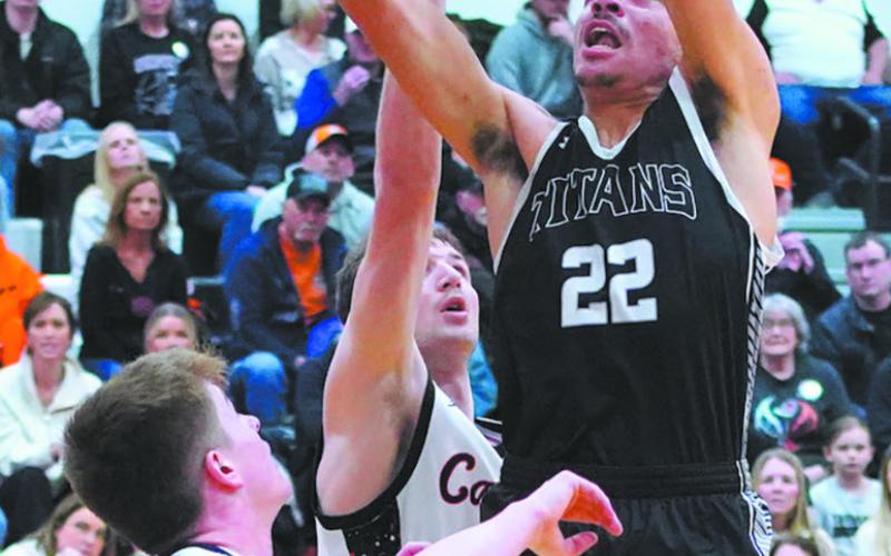 Mason Pollestad goes for the dunk during play against Cavalier in the District 3 tournament action. Photo by Larry Stokke