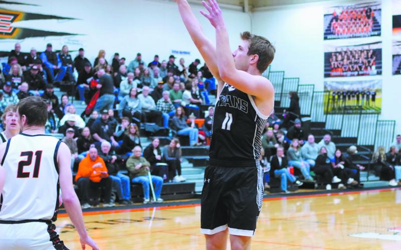 Issac Feltman sends the ball to the hoop in play against Cavalier. Photo by Larry Stokke