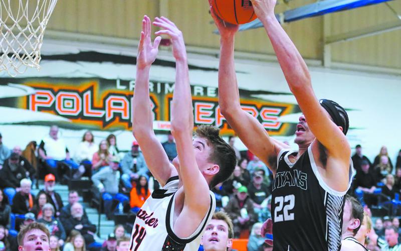 Tornadoes James Gagner attempts to block to the shot by Titans Mason Pollestad. Photo by Larry Stokke