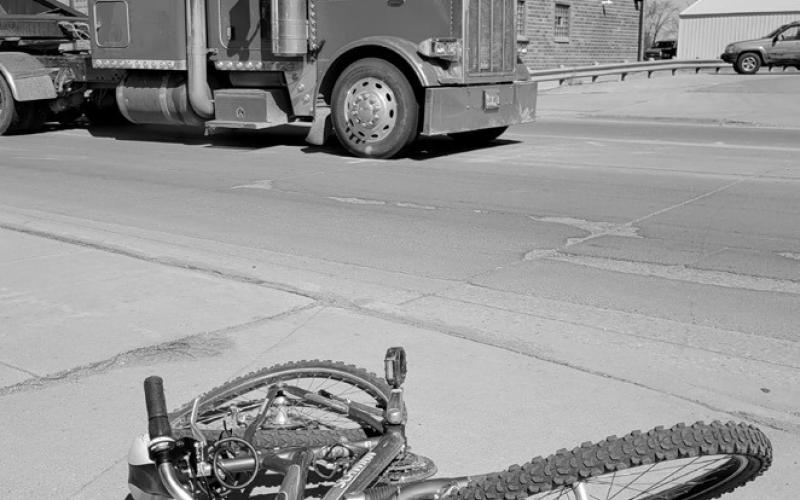 The victim's bicycle is seen lying on the sidewalk following the accident involving a semi near Hugo’s in Grafton. Photo by Mike Alan Steinfeldt
