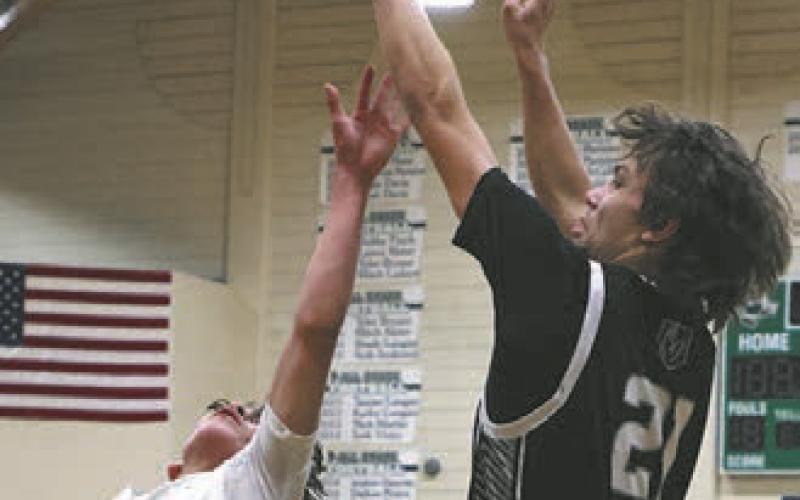 Trenten Keena shoots over St. John's Ashton Parisien at the boys play-in game on Saturday.
