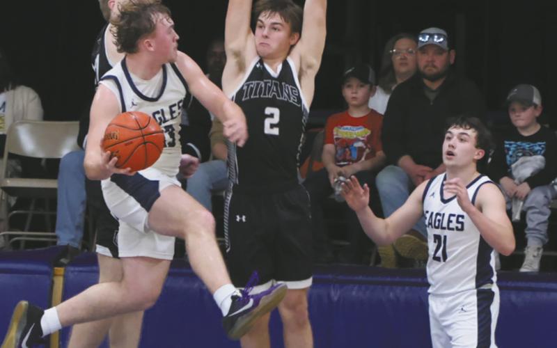 North Border's Kade Schafer attempts to move the ball to teammate Brody Berg past DVE defender Teddy Otto. Photo by Jamie Rarick