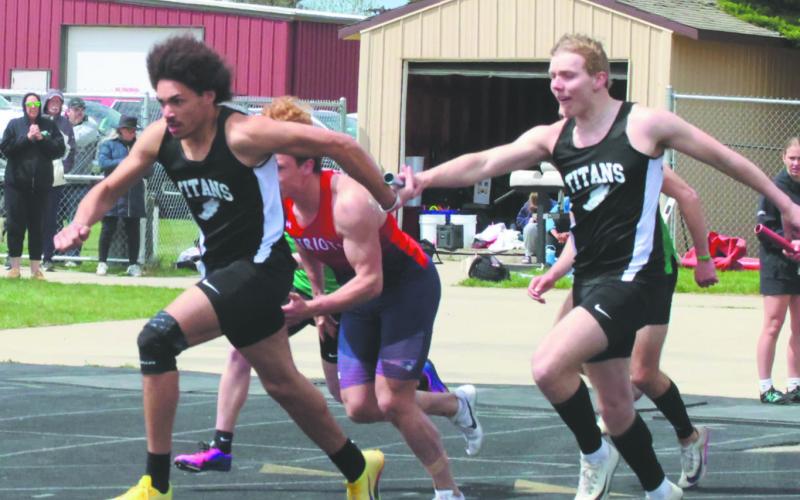 With a final baton handoff, teammates Mason Pollestad and Carter Oberg finish off the Men's 4X100 relay, winning the event for the region. Photo by Jamie Rarick