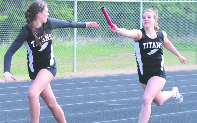 DVE's Violet Hoyles stretches forward for the hand-off to teammate Rosalyn Fedje during the Women's 4X200 Relay. Along with Cynthia Schultz and Peyton Larson, the team earned a 7th-place finish at Saturday's regional competition in Mayville. Photo by Jamie Rarick