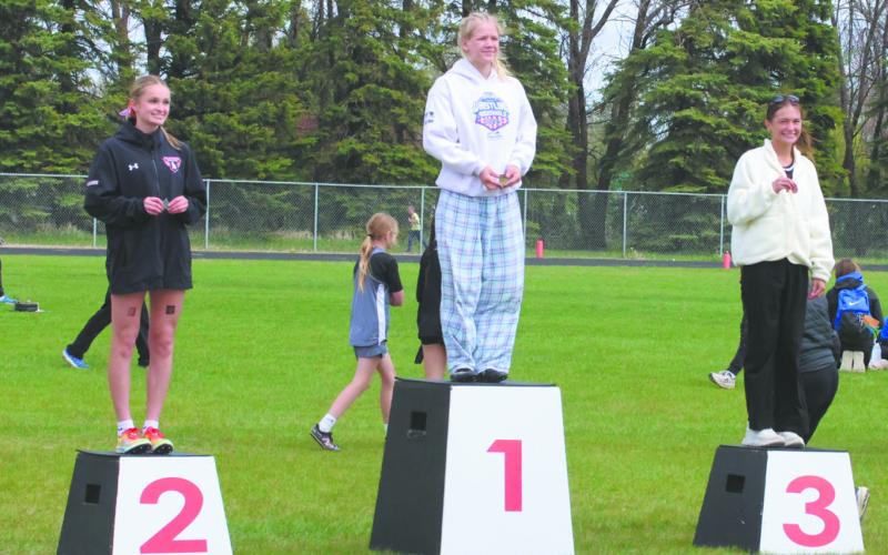 Competitors of the Women's Pole Vault take the podium at the NDHSAA North East Regional Track Meet in Mayville. In third place from Pembina County North: Addelyn Manley, in second place from Larimore: McKinley Moen, and regional champion from Drayton/Valley-Edinburg: Alyssa Hoyles with a height of 10' 6'. Photo by Jamie Rarick
