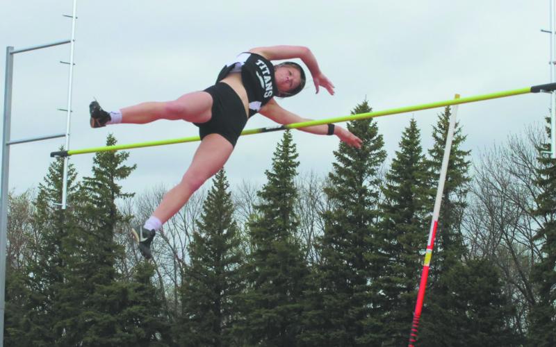 Winning by a distance of over one foot, DVE senior Alyssa Hoyles sails over the bar to clear 10' 6', locking in the title of regional champion in Women's Pole Vault. Photo by Jamie Rarick