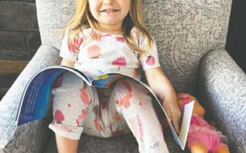 Maren Jacobson, age 3, enjoys reading an Imagination Library book.