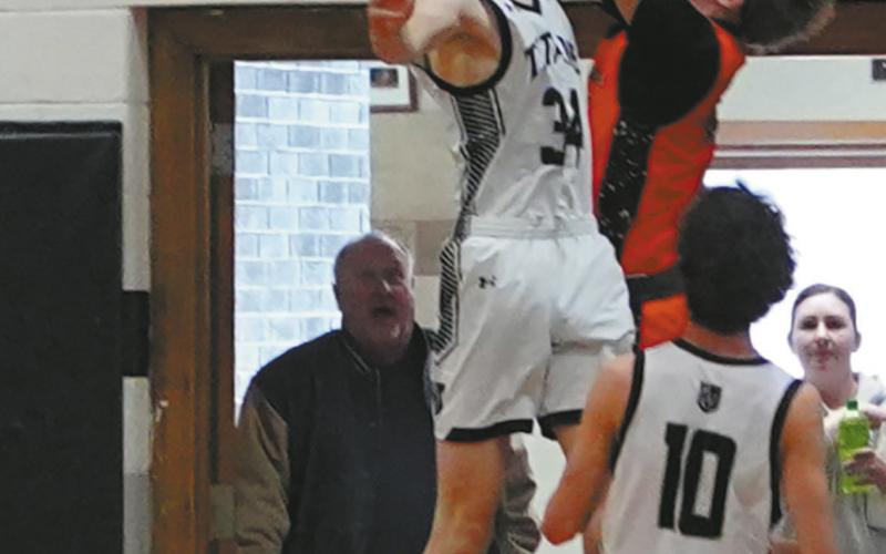 Jack Langerud gets his hand on Breckon Thorpe’s shot for a nice block against Cavalier in Edinburg on Jan. 6. Photo by Larry Stokke