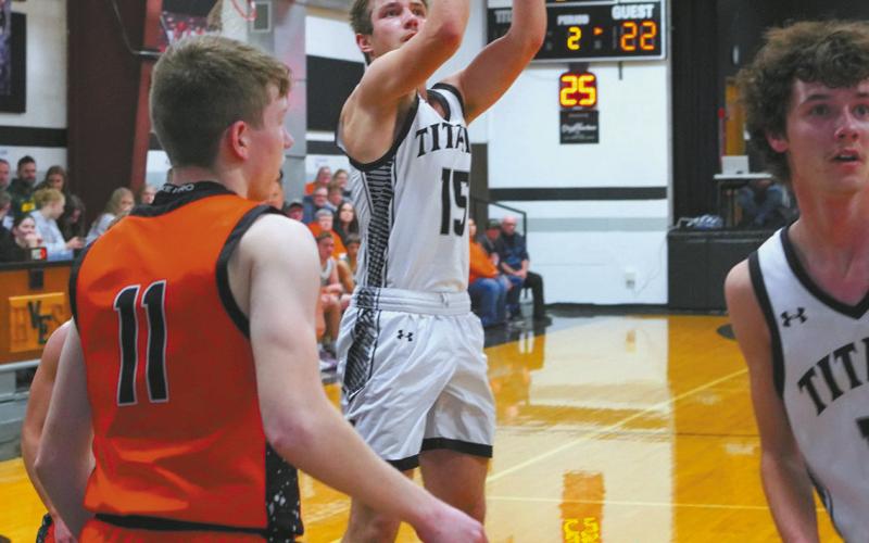 Isaac Feltman drops in a basket to help the Titans win over Cavalier by two points. Photo by Larry Stokke