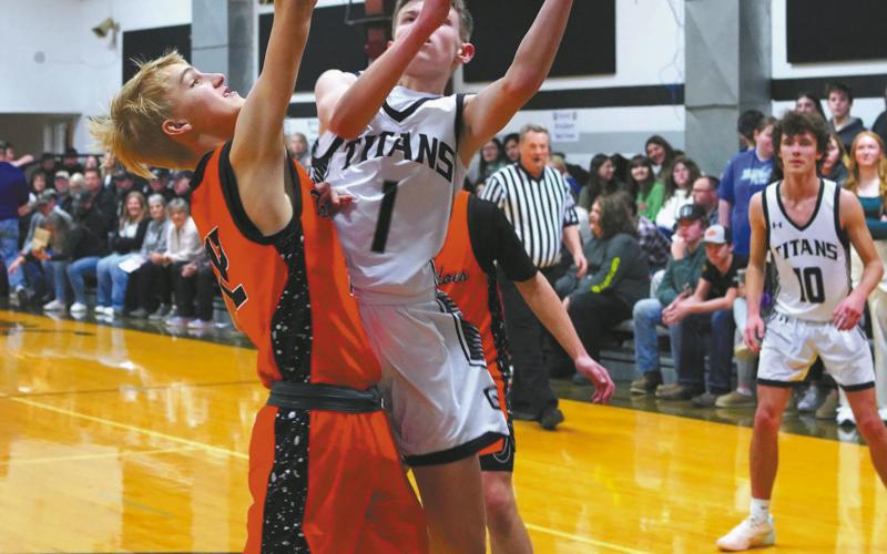 Drew Passa puts up a shot in the paint and finished the game with five threepoint baskets and a total of 18 points. Photo by Larry Stokke