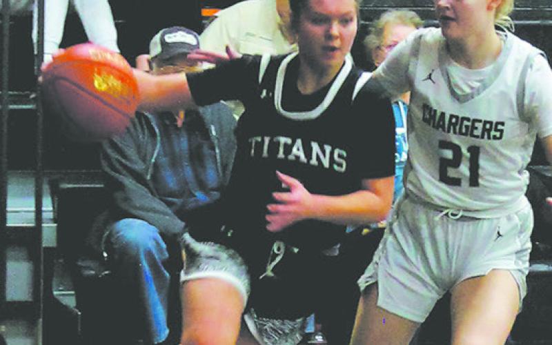 Moving from the outside, Brooke Gullickson drives towards the basket past Nelson County defender Brandi Lippert. Photo by Jamie Rarick