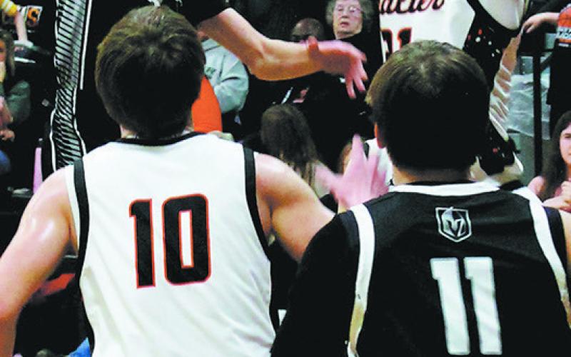 Quinn Passa jumps for the ball following a ricocheted rebound. Photo by Jamie Rarick
